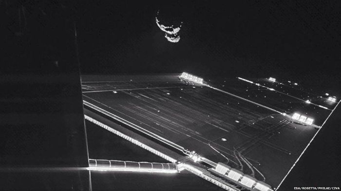 This remarkable image was captured by the CIVA imaging system aboard Philae in September 2014. Rosetta's huge solar panel "wing" can be seen in the foreground, with 67P/Churyumov–Gerasimenko tumbling through space beyond it