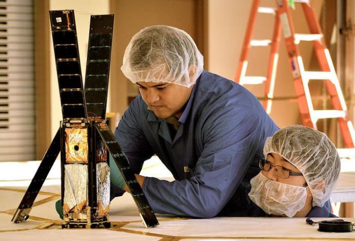 LightSail-1, which is now in orbit, seen here under final development. The 3-Cubesat tall satellite can be seen with its four solar panels open, and the 4.5-micon thick solar sail carefully stowed inside. When deployed, the sail will cover an area of 43 square metres. 