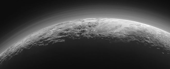 Back lit by the sun: Pluto's hazy atmosphere seen from just 18,000km (11,000 miles) and 15 minutes are the point of closest approach to the planet by the New Horizons spacecraft on July 14th, 2015. To the upper right of the planet can be seen the icy expanse of "Sputnik Planum", bordered below and to the left by tall mountains, and to the right by what appears to be glacial outflows. Image courtesy of NASA / JHU / APL,