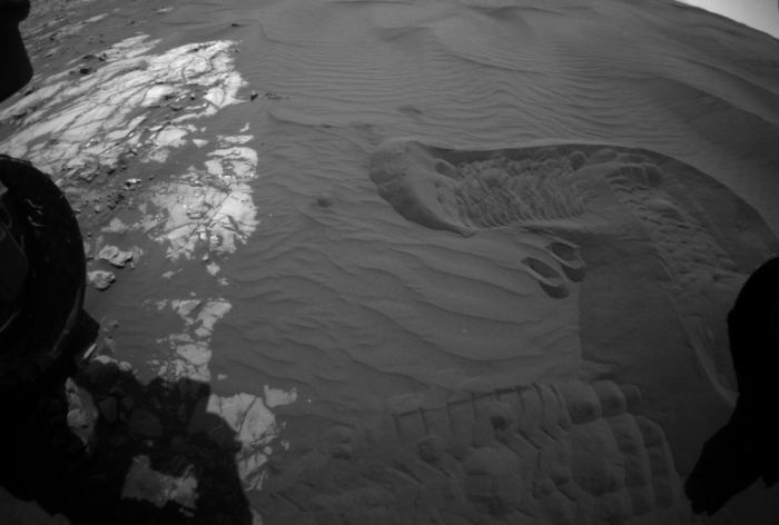 Tracks on a sand dune: this image from Curiosity's front Hazard Avoidance Camera (Hazcam) shows the rover's tracks on the same of "Namib Dune" as it starts sample gathering