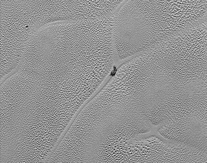A close-up of the "Sputnik Planum" ice field, showing the "cells" of ice between 16 and 38 km across, which are thought to be under motion from convection currents operating beneath them. The slug-like object in the centre of the image is believed to be a large dirty iceberg of water ice, "floating" on the denser nitrogen ice (image: NASA / JHU/APL / SwRI) 