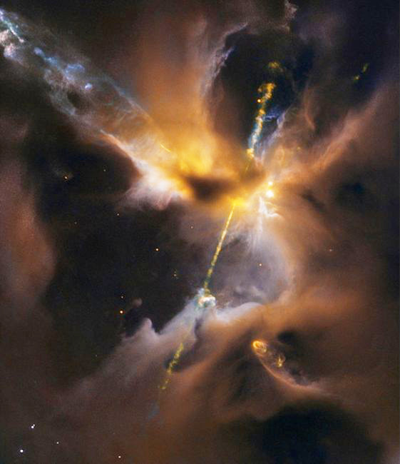 Two beams of light slice through space from the polar regions of a new-born star. Captured by the Hubble Space Telescope, the image was immediately dubbed "the cosmic lightsaber" (image: ESA / NASA / D. Padgett / T. Megeath / B. Reipurth) - click for full size