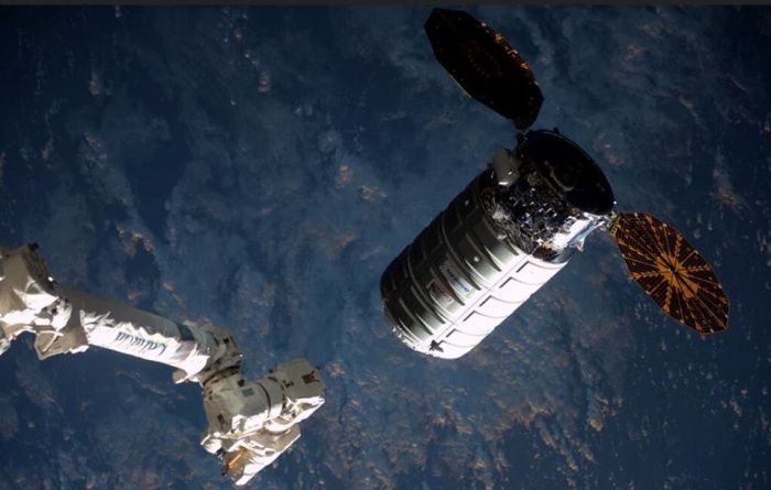 The 6 metre (20 ft) long Cygnus vehicle alongside the ISS on Saturday March 26th, 2016, as the station's robot arm prepares to grapple it