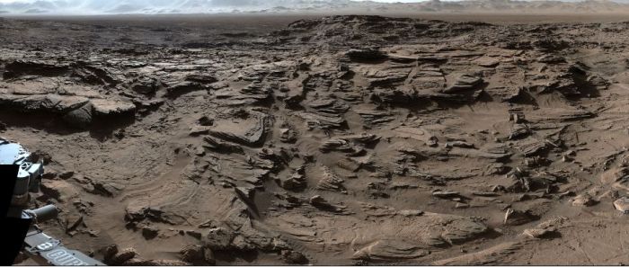 "Naukluft Plateau", which Curiosity has been traversing since March 2016, shown in close-up, revealing how the surface has been shaped and scoured by the wind over the aeons. In the distance can be seen the rim hills of Gale Crater