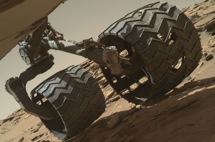 This image taken on April 18th, 2016 (Sol 1,315) by the Mars Hand Lens Imager (MAHLI) camera on the rover's robot arm revels areas of damage on Curiosity's centre left wheel, the result of periodically traversing very rough terrain since the rover arrived on Mars in 2012 