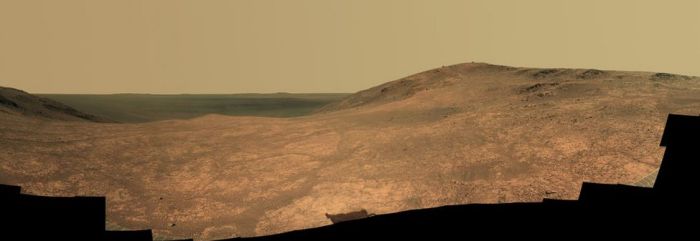 A composite mosaic of images captured by Opportunity's panoramic imaging system in April / May 2016, showing the fractured nature of Marathon Valley in the foreground and the darker mass of Endeavour crater beyond. Credit: NASA/JPL / Cornell Univ. / Arizona State Univ.