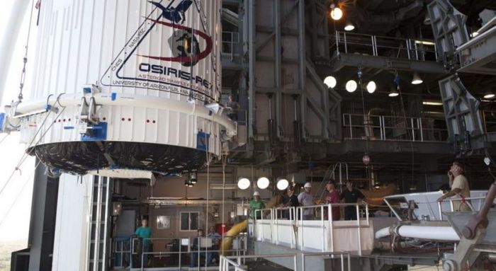 OSIRIS-REx (l) about to be mated to the Atlas V payload fairing in a clean room at NASA's The Atlas V payload fairing containing OSIRIS-Rex is hoisted to the top of the Launch Complex 41 gantry, ready for mating to the Atlas V booster, August 29th. Credit: NASA / Dimitri Gerondidakis