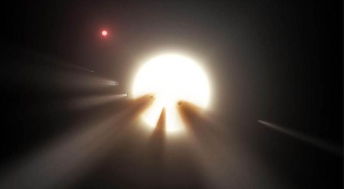 Artist’s impression of an orbiting swarm of dusty comet fragments around Tabby’s Star. Could these be responsible for its peculiar dips in brightness or is there a biological reason? A small red dwarf star (above, left) lies near Tabby’s. Credit: NASA / JPL