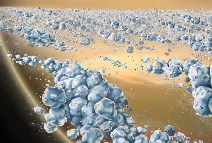 A 2007 artist impression of the aggregates of icy particles that form the 'solid' portions of Saturn's rings. These elongated clumps are continually forming and dispersing. The largest particles are a few metres across. Credit: NASA/JPL / University of Colorado