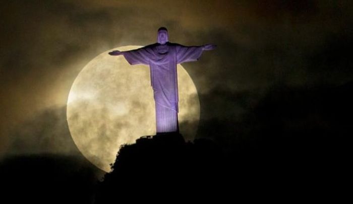 A dramatic supermoon is seen behind the Christ the Redeemer statue in Rio de Janeiro, in May 2012. Credit: AP Photo/Victor R. Caivano 