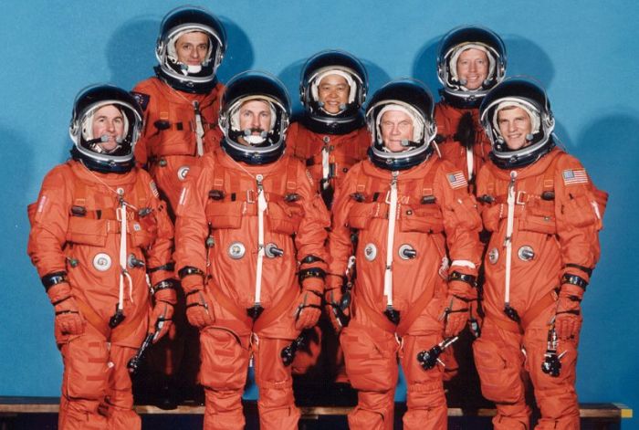 The STS-95 Discovery crew in a pose reminiscent of some of the Mercury 7 publicity shots. (l-r): Stephen K. Robinson; Pedro Duque (ESA); Curtis L. Brown Jr. (Mission Commander); Chiaki Mukai (NASDA); Senator John Glenn; Steven W. Lindsey (Shuttle Pilot) and Scott F. Parazynski. Credit: NASA 