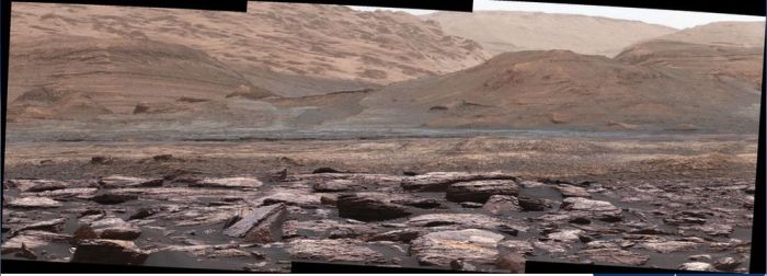 A mosaic of Mastcam images captured by NASA's Curiosity rover on November 10th, 2016 (Sol 1,516), showing the lower slopes of "Mount Sharp". Variations in the rocks colour hint at the diversity of their composition. The purple tone of the foreground rocks has been seen in other rocks where hematite has been detected. Winds and windblown sand help to keep rocks relatively free of dust which would otherwise obscure their colour differentiation. These images have been white balanced, so the scene appears as it would under typical Earth daylight conditions 